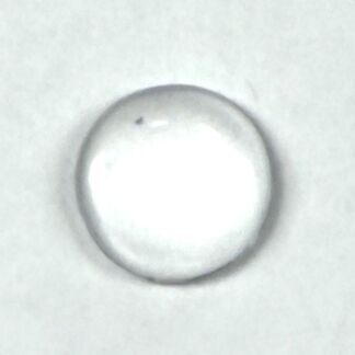 Close-up of a single transparent water droplet resting on a white surface