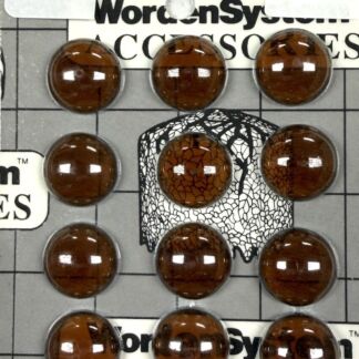 Brown glass marbles arranged on a gray grid board with label patches reading 'No. 18' and 'Smokey Topaz' and a cracked black-and-white center design.